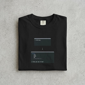 May include: Black t-shirt featuring code snippets. The design includes '> script.py' above an arrow, leading to file paths and the text '// this got out of hand'. A Comfort Colors label is visible.