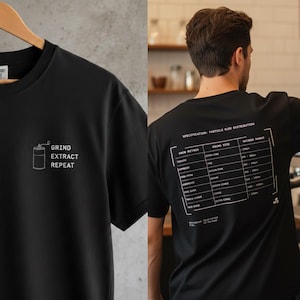 May include: Black t-shirt with white text and a coffee grinder graphic. The front of the shirt says "GRIND EXTRACT REPEAT." The back of the shirt has a coffee brewing specification chart.