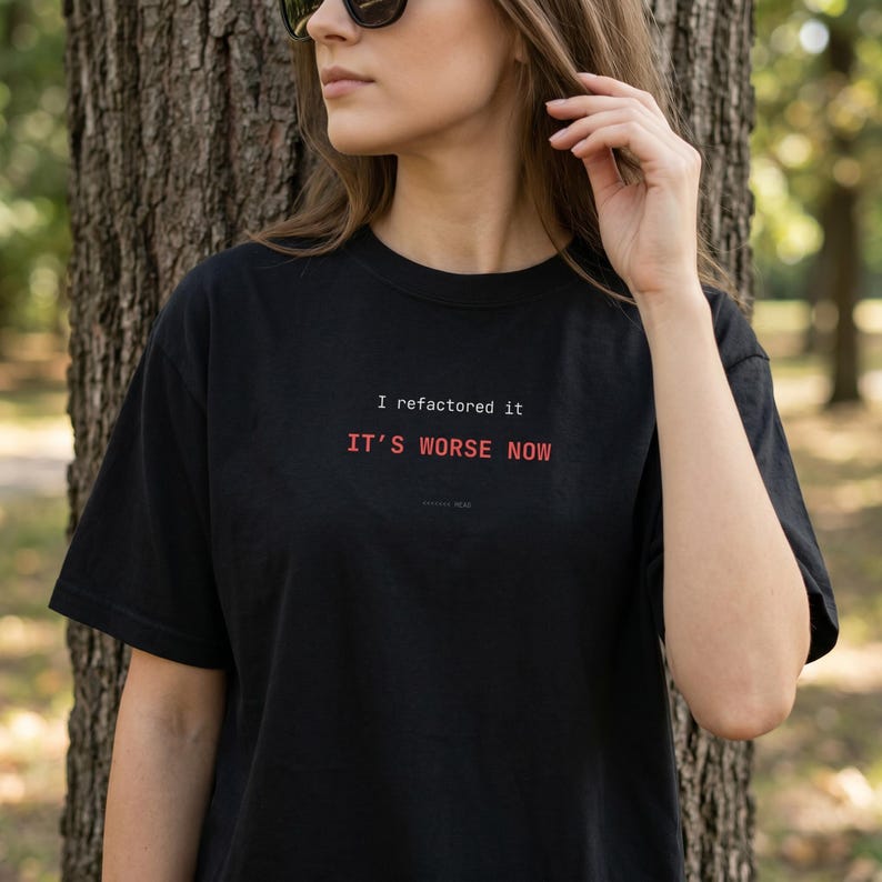 Puede incluir: Camiseta negra con el texto "I refactored it, it's worse now" en blanco y rojo. La camiseta es de estilo cuello redondo y manga corta.