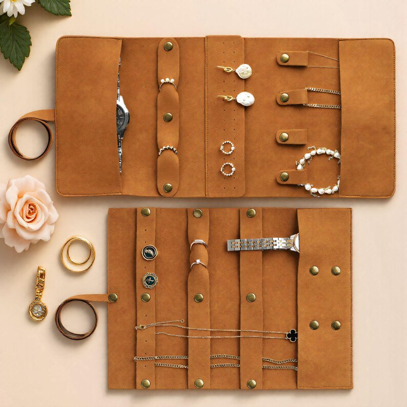 May include: A brown leather jewelry organizer, open to display various pieces. The organizer features multiple compartments for rings, earrings, necklaces, bracelets, and a watch. Gold and silver jewelry is visible, including a watch with a silver band.