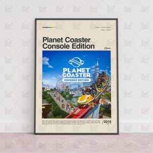 May include: A framed poster for the video game "Planet Coaster: Console Edition." The poster features a vibrant image of a roller coaster with riders, a Ferris wheel, and a blue sky. The game's logo and title are prominently displayed in white and blue.