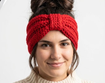 May include: A bright red knitted headband featuring a thick, chunky yarn texture and a central knotted detail. The accessory is crafted with a ribbed pattern that runs horizontally across the band, providing a consistent and textured appearance.
