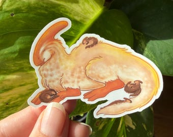 May include: A die-cut sticker featuring a light orange and cream-colored parasaurolophus dinosaur with a long crest, lying down with small brown creatures resting on its back, near its front paws, and near its tail, all with a white border.