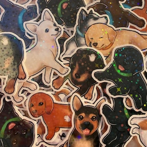 May include: A collection of die-cut stickers featuring various puppy breeds including a white chihuahua, a golden retriever, and a black labrador, all finished with a holographic star pattern overlay that reflects light across the surface.