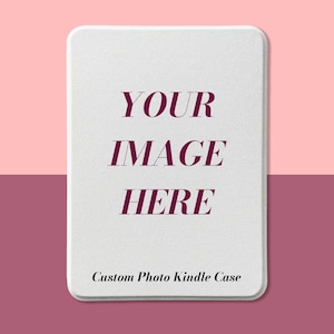 May include: A white Kindle case with rounded corners, featuring the text "YOUR IMAGE HERE" in a burgundy font. The words "Custom Photo Kindle Case" are at the bottom. The background is split between pink and burgundy.