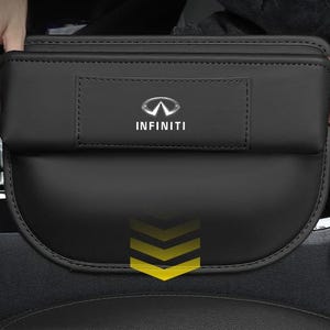 May include: Black car seat organiser featuring the Infiniti logo. The organiser is made of a smooth, leather-like material and has multiple compartments. The Infiniti logo is in silver. Designed to fit between car seats.
