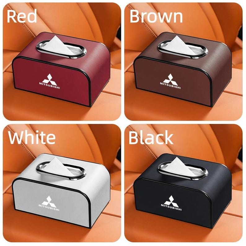 K&ouml;nnte beinhalten: Vier Taschentuchboxen in Rot, Braun, Wei&szlig; und Schwarz. Jede Box hat eine silberfarbene ovale &Ouml;ffnung zur Taschentuchausgabe und ein Mitsubishi-Logo. Die Boxen sind rechteckig mit abgerundeten Kanten.