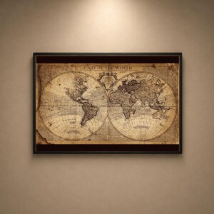 May include: A framed vintage-style world map print featuring a sepia-toned parchment background with two circular hemispheres. The text at the top reads A MAP OF THE WORLD. The map displays detailed continental outlines, latitude lines, and ocean labels.