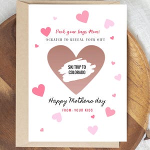 May include: A Mother's Day card with a brown heart-shaped scratch-off area revealing "SKI TRIP TO COLORADO." The card features pink hearts and the phrases "Pack your bags Mom!" and "Happy Mothers day FROM: YOUR KIDS."