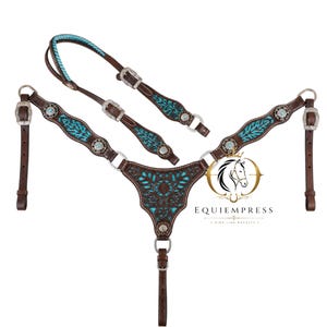 May include: A brown leather horse breast collar and matching headstall featuring turquoise inlay with intricate floral cutouts, silver-toned buckles, and decorative conchos. The logo EQUIEMPRESS RIDE LIKE ROYALTY is printed in gold and black on the right side.
