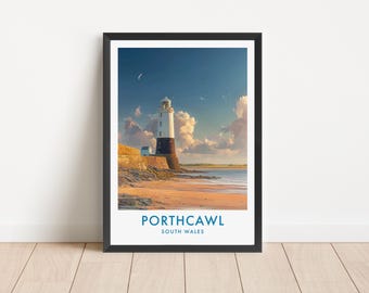 May include: A framed art print featuring a lighthouse on a sandy beach at Porthcawl, South Wales. The lighthouse has a white upper section and a dark base, set against a blue sky with clouds. The text PORTHCAWL SOUTH WALES is printed below.