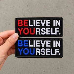 May include: Two rectangular embroidered patches with black backgrounds and white borders. The top patch features the text BE in red and LIEVE IN YOURSELF in white. The bottom patch features the text BE in blue and LIEVE IN YOURSELF in white.