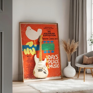 Woodstock Music & Art Fair poster with vintage electric guitar and dried grasses.
