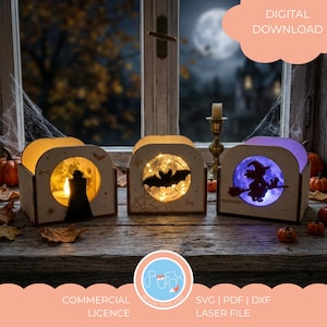 Könnte beinhalten: Drei lasergeschnittene Holzlaternen mit Halloween-Silhouetten eines Vampirs, einer Fledermaus und einer Hexe auf einem Besen. Jede Box enthält LED-Lichter, wobei die Vampir-Box gelb, die Fledermaus-Box warmweiß und die Hexen-Box violett leuchtet.