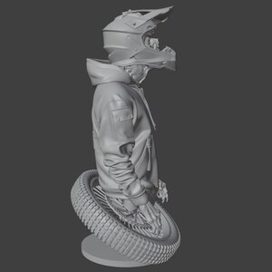 May include: A gray sculpture of a person wearing a motocross helmet and a hooded jacket, leaning on a tire. The tire is mounted on a round base. The sculpture is a 3D rendering.