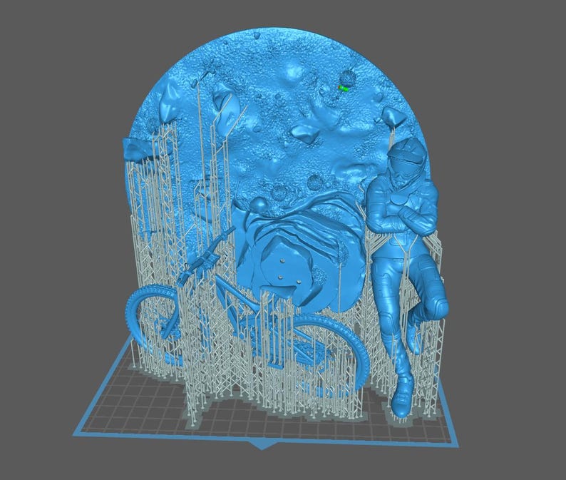May include: A blue 3D-printed sculpture featuring a person in a spacesuit leaning against a motorcycle, with a textured backdrop resembling a moon surface. The sculpture is supported by a grid-like base and support structures.