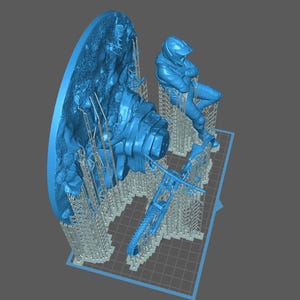 May include: A blue 3D-printed model featuring a motorcycle, a rider in a helmet, and a detailed landscape element. The model is supported by a grid-like structure, suggesting it's in the printing process. The overall theme is likely related to motorsports or model-making.