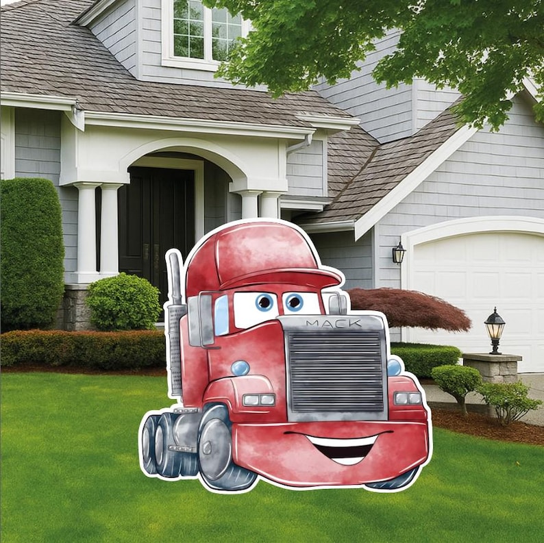 May include: A red cartoon truck yard sign featuring a smiling face, large eyes, and a grey grille with the word MACK printed on the front. The truck has a red cab, a vertical exhaust pipe, and black wheels, designed as a flat decorative cutout.