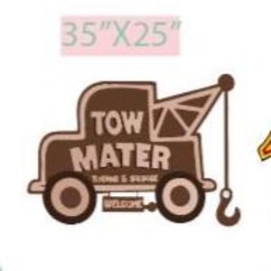 May include: A brown and beige sign featuring a cartoon tow truck with the text "TOW MATER" and "TOWING & STORAGE". The sign measures 35" x 25" and includes a hook and the word "WELCOME".