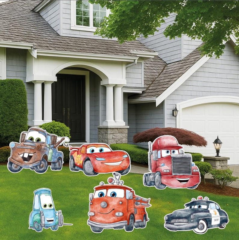 May include: A collection of six cartoon vehicle yard signs featuring a brown tow truck, a red race car, a red semi-truck, a light blue small car, a red fire truck, and a black and white police car, all displayed on a green lawn.