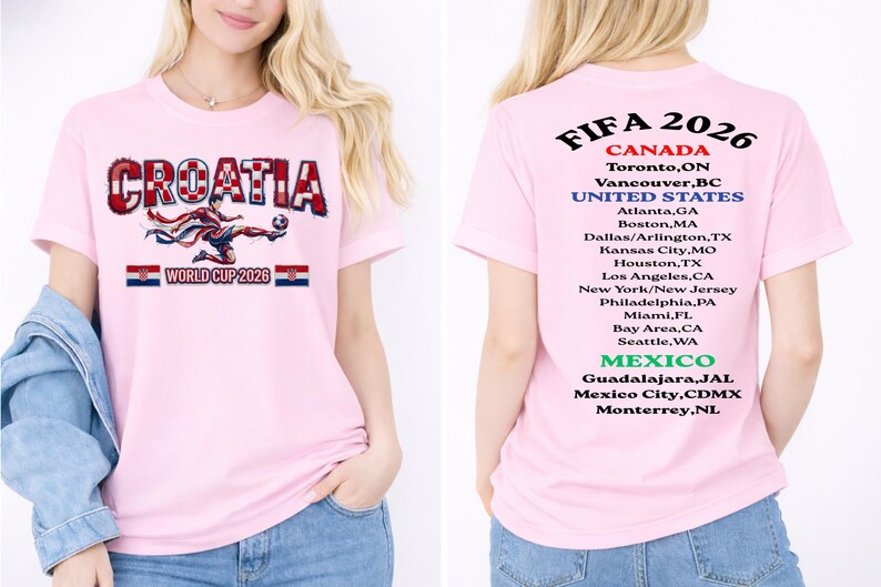 May include: Pink t-shirt featuring the word "CROATIA" in a red and white checkered design, with a soccer player graphic and "WORLD CUP 2026" text. The back of the shirt lists FIFA 2026 host cities in Canada, the United States, and Mexico.
