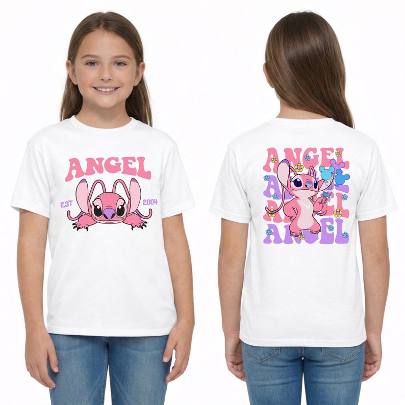 May include: A white t-shirt featuring a pink cartoon character on the front with the text ANGEL EST 2004. The back displays the same pink character surrounded by repeating purple and pink ANGEL text and small colourful flower graphics.