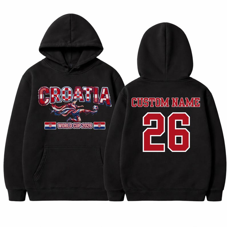 May include: Black hooded sweatshirt featuring "CROATIA" in a red and white checkered design, with a soccer player graphic. The front also displays "WORLD CUP 2026". The back has "CUSTOM NAME" and the number "26" in red.