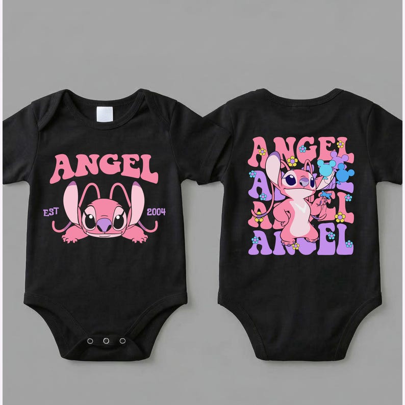 May include: Two black baby bodysuits featuring a pink character graphic. The left bodysuit displays the text ANGEL EST 2004. The right bodysuit shows the character Angel surrounded by the word ANGEL in a repeating pattern with small colourful flowers.