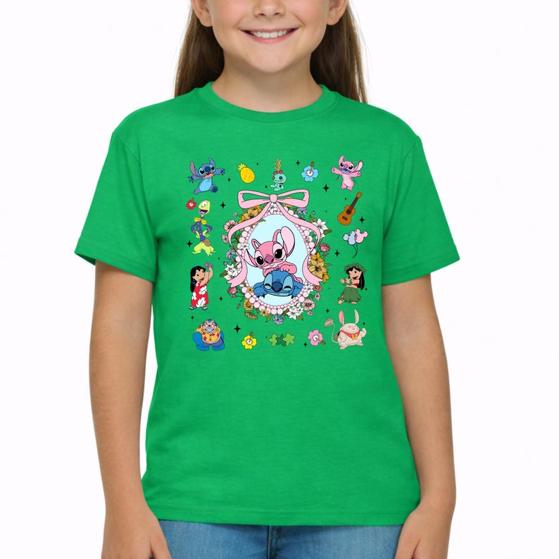 May include: A bright green short-sleeved t-shirt featuring a central oval frame decorated with flowers and a pink bow, containing illustrations of Stitch and Angel. The surrounding area displays various small character icons and floral motifs.