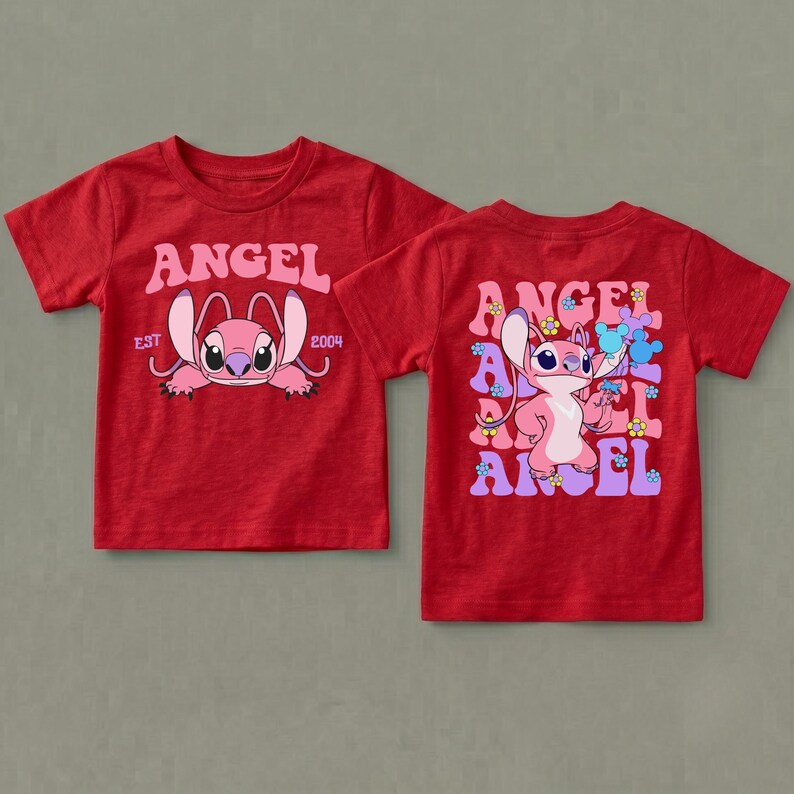 May include: A red short-sleeve t-shirt featuring a pink Angel character graphic. The front displays the text ANGEL EST 2004. The back shows a repeating ANGEL text pattern with the character and small colourful flower and mouse-ear icons.