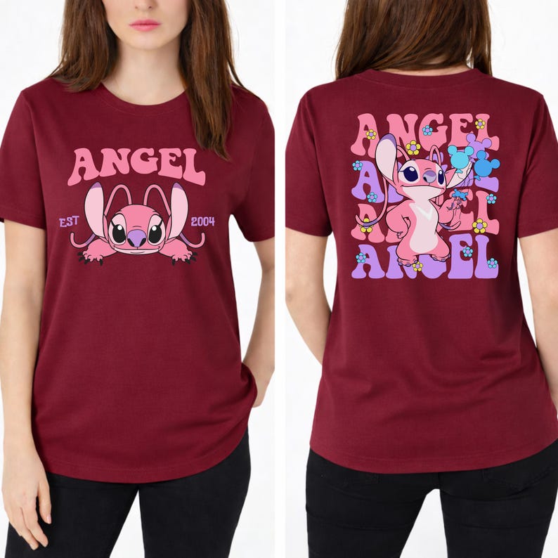 May include: A maroon short-sleeved t-shirt featuring a pink character graphic. The front displays the text ANGEL EST 2004. The back shows the character surrounded by repeating ANGEL text, small flowers, and blue mouse-ear silhouettes in a grid pattern.