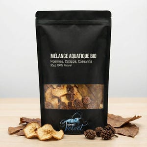 May include: A black pouch with a clear window displaying dried apple slices and other natural elements. The pouch has text that reads "MÉLANGE AQUATIQUE BIO" and "Velvet" in a script font. The product is labeled as 50g and 100% Natural.