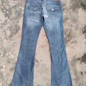 May include: A trio of ceramic mugs with a speckled, matte finish in light blue, cream, and grey. The mugs have a simple, modern design and a comfortable handle, perfect for tea or coffee.