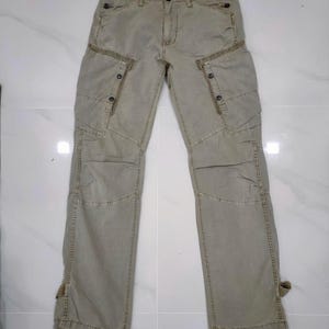 May include: A set of three ceramic vases in varying sizes. The vases have a matte finish in shades of cream, beige, and brown. The tallest vase is approximately 10 inches tall.