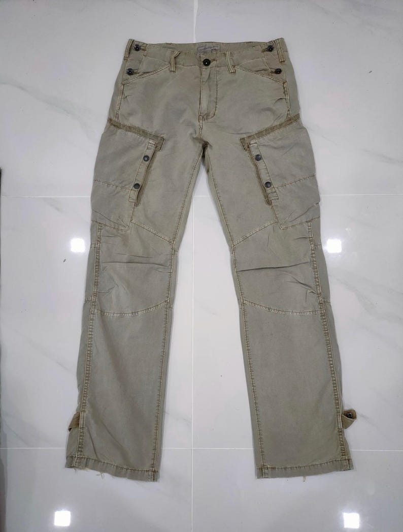 May include: A set of three ceramic vases in varying sizes. The vases have a matte finish in shades of cream, beige, and brown. The tallest vase is approximately 10 inches tall.