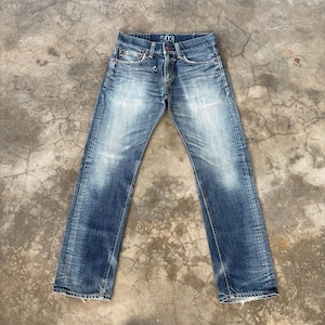 May include: Faded blue denim jeans with a button fly and the number "503" printed on the waistband. The jeans have a classic five-pocket design and show signs of wear and fading, giving them a vintage look.