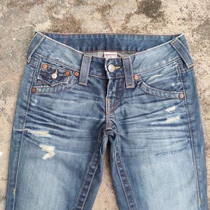 May include: A rustic wooden sign with the text "Welcome to our home" in white lettering. The sign has a distressed finish and a simple, inviting design, ideal for front door decor.