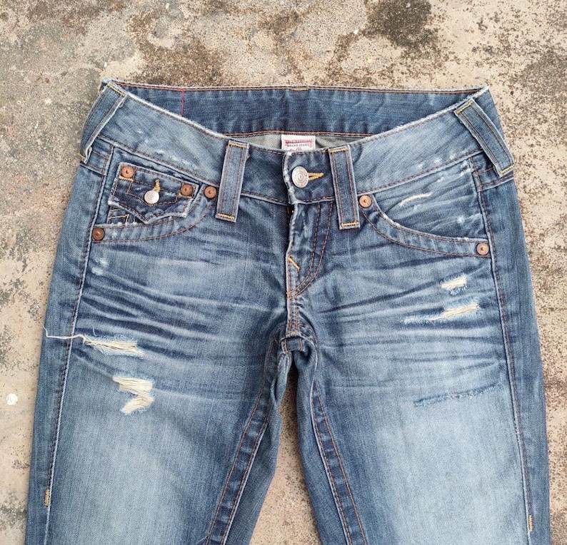 May include: A rustic wooden sign with the text "Welcome to our home" in white lettering. The sign has a distressed finish and a simple, inviting design, ideal for front door decor.