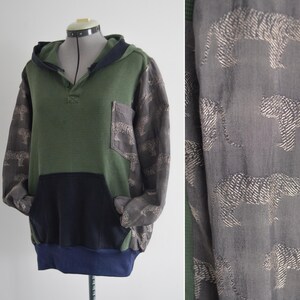 May include: A set of three ceramic mugs with a speckled, matte finish. The mugs are in shades of cream, light gray, and dark gray. Each mug has a simple, minimalist design, suitable for coffee or tea.