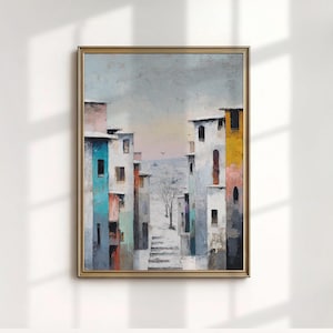 May include: An abstract painting in a gold frame depicts a street scene with colorful buildings. The buildings are painted in shades of blue, pink, yellow, and white. A bare tree stands in the distance, and the sky is a pale gray.