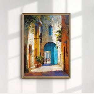May include: Oil painting depicting a European street scene with a striking blue archway. The artwork uses textured brushstrokes and a warm palette of orange, yellow, and white, with green foliage and figures in the distance. Presented in a gold frame.