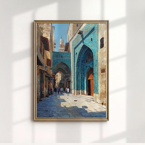 May include: A framed oil painting depicts a Middle Eastern street scene. The artwork features a blue archway and buildings with intricate details. The color palette includes shades of blue, brown, and beige, with people walking along the cobblestone street.