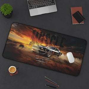 May include: A rectangular desk mat featuring a black muscle car driving through a dusty landscape at sunset. The text reads Muscle, Car, and Bonneville Salt Flats. The design includes warm orange and yellow sky tones contrasting with the dark vehicle.