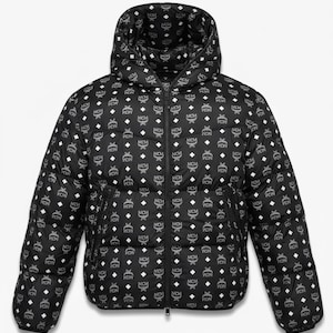 May include: Black puffer jacket with a hood, featuring a repeating pattern of white MCM logos. The jacket has a full-length zipper and a quilted design. A stylish outerwear piece.