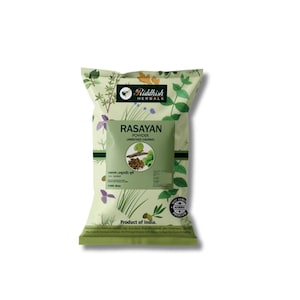 May include: A light green bag of Riddhish Herbals Rasayan Powder (Amrutadi Churna). The bag features a central green label with product information and a circular logo. The bag is decorated with floral and herbal illustrations and the text "Product of India."