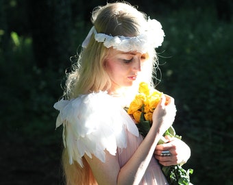 White angel wings. White feathered shoulder pieces.