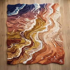 May include: A rectangular tufted rug featuring an abstract landscape design with wavy, layered textures. The color palette transitions from deep navy blue and purple at the top to warm shades of terracotta, ochre, gold, and cream toward the bottom.