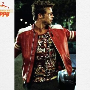 May include: A red leather jacket with white accents on the shoulders and sleeves. The jacket is worn over a patterned shirt. The image is from Jackets Co Poppy.