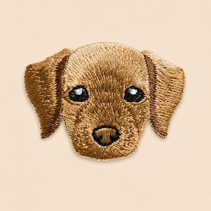May include: An embroidered patch featuring the head of a golden-brown dog with floppy ears. The design includes detailed stitching in shades of tan and gold, with black thread used for the nose and eyes, which feature small white highlights.