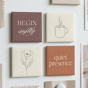 May include: Four square decorative tiles in shades of brown and cream. One tile reads "BEGIN softly" in white script. Another features a coffee cup outline. A third tile has a floral sketch, and the last says "quiet presence".